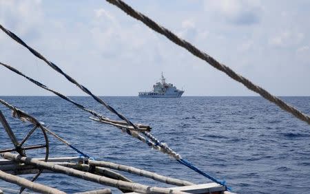 A China Coast Guard ship is seen from a Philippine fishing boat at the disputed Scarborough Shoal April 6, 2017. REUTERS/Erik De Castro