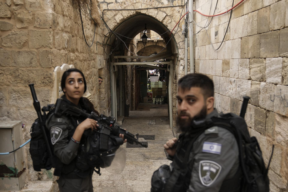 Israeli border police officers stand guard next to the scene of a stabbing attack in Jerusalem's Old City, Thursday, Nov. 3, 2022. A Palestinian stabbed a police officer lightly wounding him, and officers opened fire on the attacker, killing him, Israeli police said. (AP Photo/Mahmoud Illean)