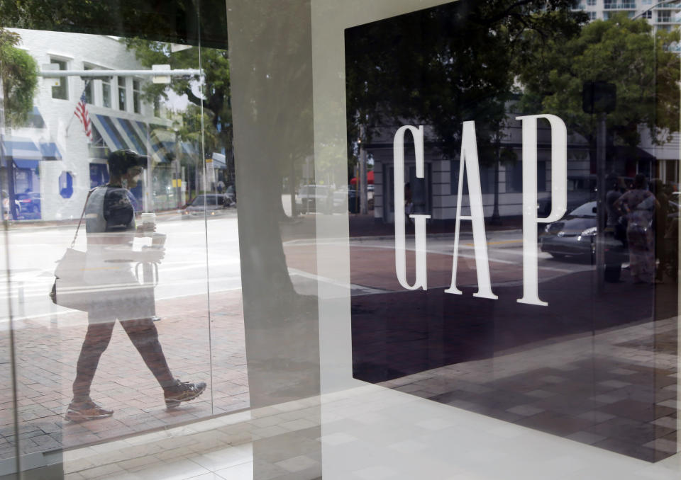 FILE - In this Aug. 15, 2015, file photo, a pedestrian walks past a Gap store in Miami. (AP Photo/Lynne Sladky, File)