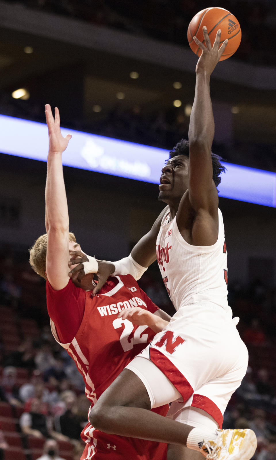 Nebraska's Eduardo Andre, right, shoots against Wisconsin's Steven Crowl (22) during the first half of an NCAA college basketball game Thursday, Jan. 27, 2022, in Lincoln, Neb. (AP Photo/Rebecca S. Gratz)