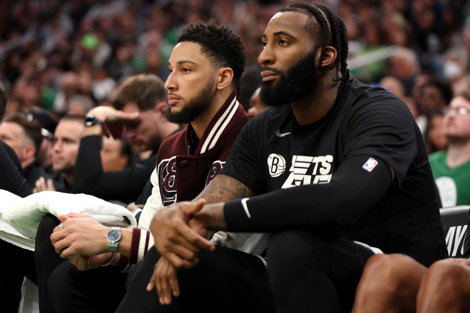 Ben Simmons (pictured left) of the Brooklyn Nets and Andre Drummond (pictured right) look on from the bench during an NBA game.