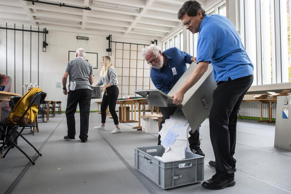 FILE - Volunteers empty the ballot boxes at a polling station in Zurich, Switzerland, on Oct. 20 2019. On Sunday Oct. 22, 2023 Swiss voters elect the two houses of parliament, an exercise every four years that will ultimately shape the future composition of the Alpine country’s executive branch: The Federal Council. (Ennio Leanza/Keystone via AP, File)