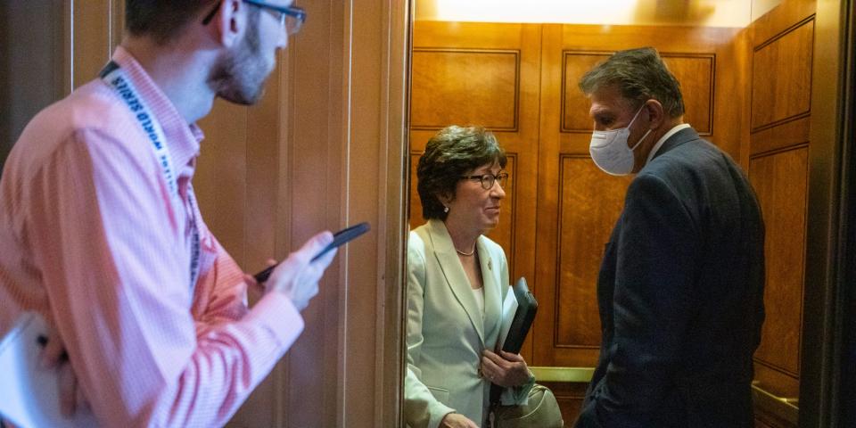 Susan Collins and Joe Manchin talk in a Senate elevator