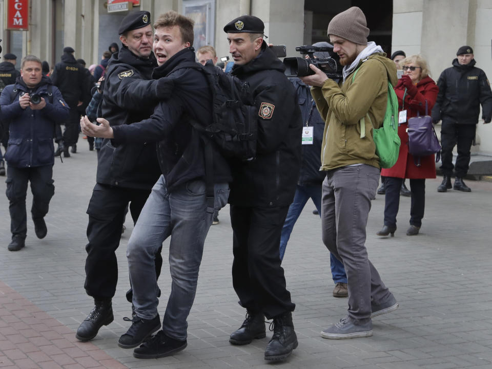 Belarus police detain journalist Roman Protasevich in Minsk, Belarus, Sunday, March 26, 2017. Dozens protestors were detained during attempt to rally in downtown Minsk. (AP Photo/Sergei Grits)