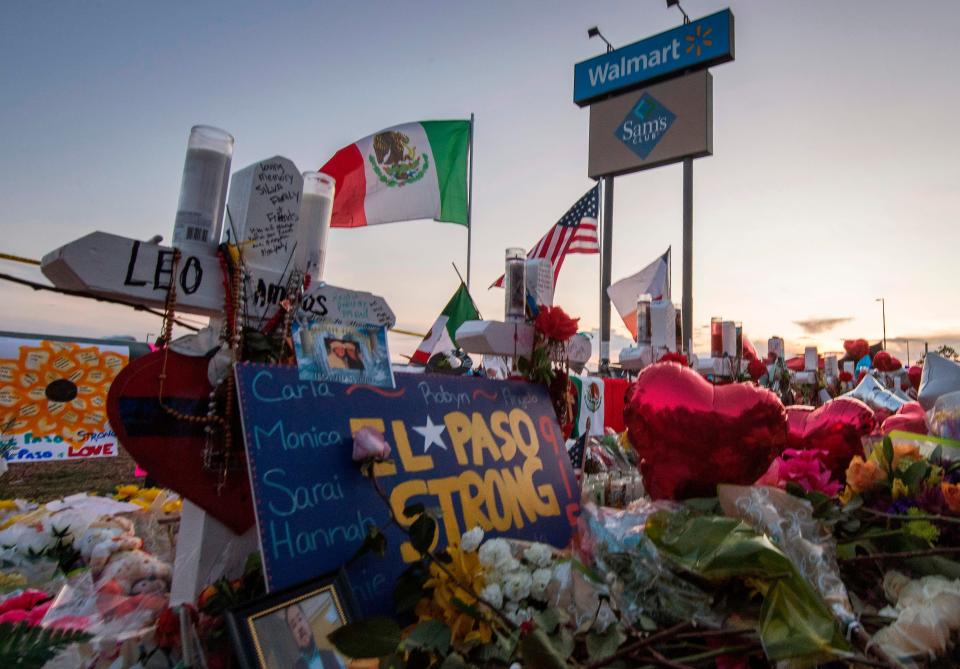 People pray and pay their respects at a makeshift memorial for victims of a shooting in El Paso, Texas.