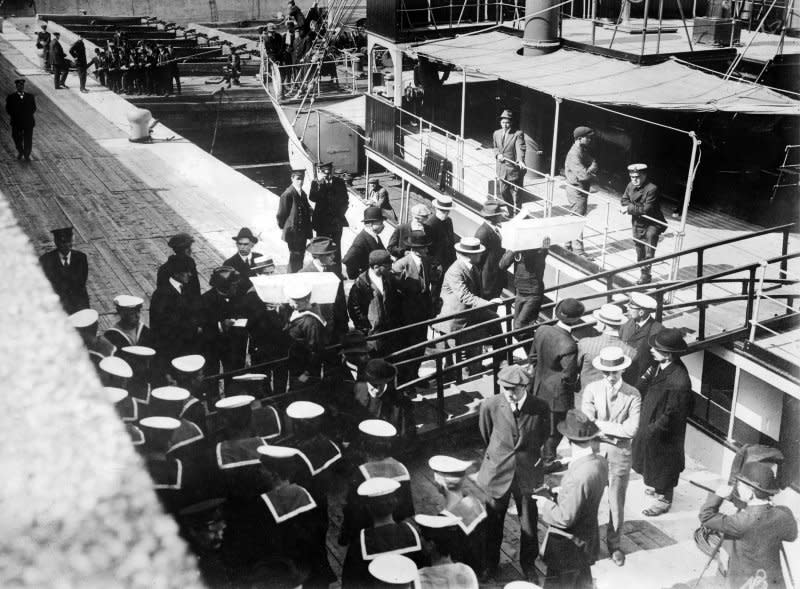 Sailors remove coffins from the Lady Gray at port in Quebec following the sinking of the RMS Empress of Ireland ocean liner on May 28, 1914. More than 1,000 people perished in the tragedy one day earlier. File Photo by Library of Congress/UPI