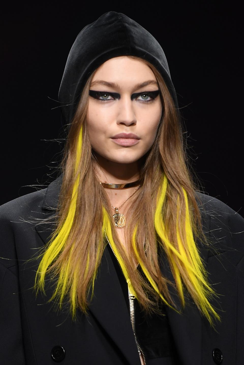 For the Versace fall 2017 show, Bella Hadid's hair had red extensions glued in and we think she looks amazing.