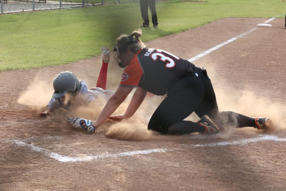 SJCC's Avery Naderer is safe on a play at the plate.