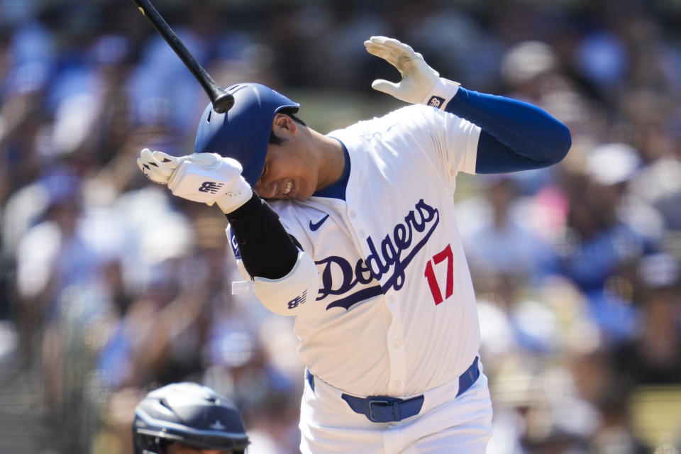 Los Angeles Dodgers designated hitter Shohei Ohtani reacts after being hit by a pitch from Tampa Bay Rays relief pitcher Richard Lovelady during the eighth inning of a baseball game in Los Angeles, Sunday, Aug. 25, 2024. (AP Photo/Ashley Landis)