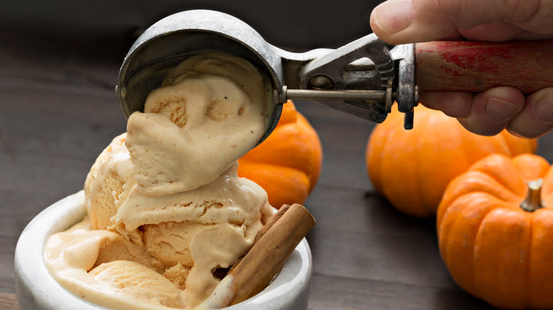 Pumpkin ice cream being scooped