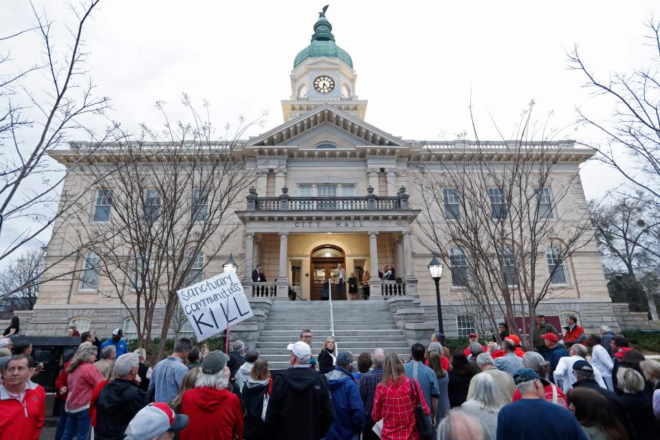 A large crowd gathered to call for change and the resignation of Athens-Clarke County Mayor Kelly Girtz during a "Make Athens Safe Again" demonstration at city hall in downtown Athens on Tuesday. The demonstration was organized after the death of nursing student Laken Riley on the UGA campus.