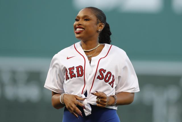 Jennifer Hudson smiles after throwing out the ceremonial first pitch before a baseball game between the Boston Red Sox and the New York Yankees, Friday, Aug. 12, 2022, in Boston. (AP Photo/Michael Dwyer)