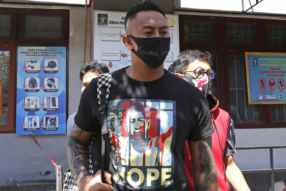 Australian national William Cabantog, center, leaves Kerobokan prison in Bali, Indonesia Saturday, July 25, 2020. Cabantog is released from the prison where he has served to twelve months. Cabantog and another man were arrested last July at the Lost City Club on Indonesia's resort island of Bali with 1.12 grams of cocaine. (AP Photo/Firdia Lisnawati)