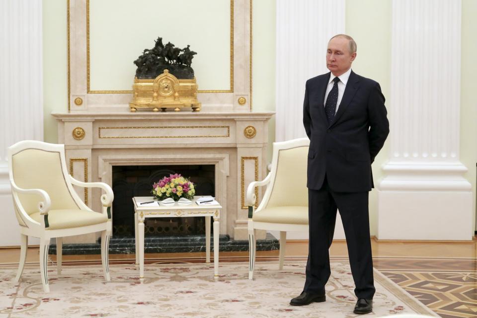 Russian President Vladimir Putin stands while waiting for Belarusian President Alexander Lukashenko prior to their talks in Moscow, on March 11. [Mikhail Klimentyev, Sputnik, Kremlin Pool Photo via AP, File)