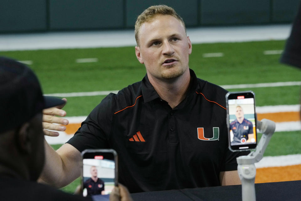 Miami's quarterback Tyler Van Dyke answers questions during NCAA college football media day, Monday, July 31, 2023, in Coral Gables, Fla. (AP Photo/Marta Lavandier)
