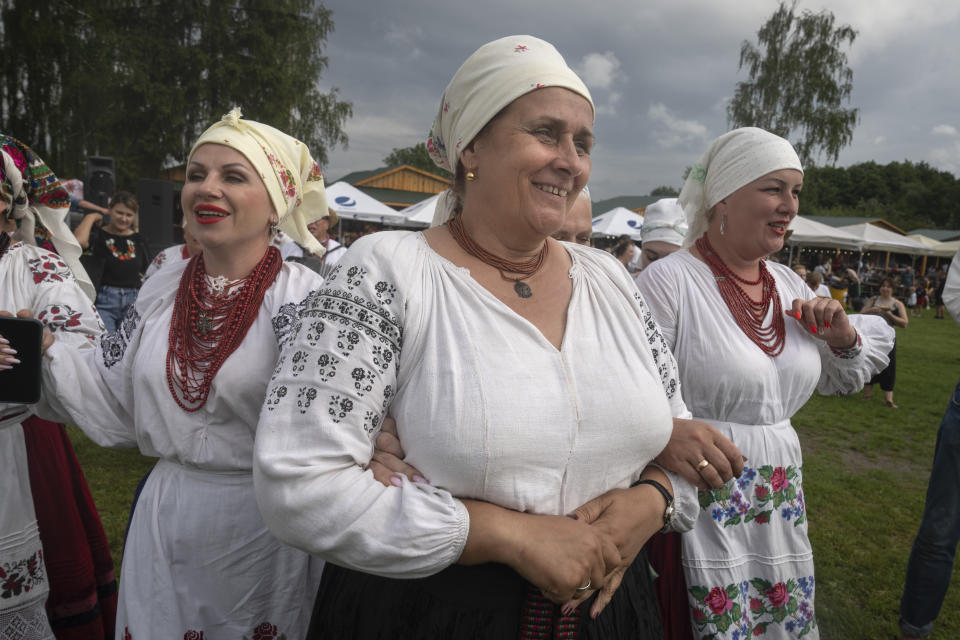 Ukrainian women dressed in traditional clothing sing songs at a traditional Midsummer Night celebration near capital Kyiv, Ukraine, Sunday, June 23, 2024. The age-old pagan festival is still celebrated in Ukraine amid the third year of Russia-Ukraine war. (AP Photo/Efrem Lukatsky)