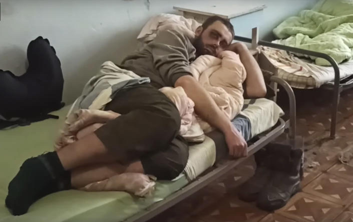 In this photo taken from video released by the Russian Defense Ministry on Wednesday, May 18, 2022, shows a wounded Ukrainian servicemen lying in a hospital in Novoazovsk, Ukraine, in territory under the government of the Donetsk People's Republic, after he an his comrades were evacuated from Azovstal steel plant in Mariupol. (Russian Defense Ministry Press Service via AP)