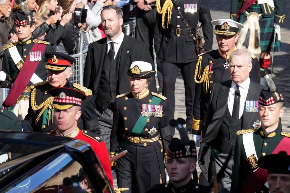 King Charles III, Princess Anne, Prince Andrew, and Vice Admiral Timothy Laurence walk behind the hearse carrying Queen Elizabeth II’s coffin on Monday (Getty Images)