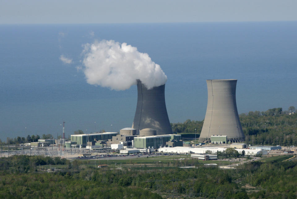 FILE-This May 20, 2005 file photo shows the Perry Nuclear Power Plant on the shores of Lake Erie in North Perry, Ohio. Across the nation, a handful of nuclear plants unable to compete with natural gas and renewable energy have shut down within the last two years, taking away steady and lucrative sources of tax money for schools, roads and libraries. The uncertainty surrounding the future of both Ohio plants, Davis-Besse near Toledo and Perry near Cleveland, has created plenty of nervousness in their hometowns that have found themselves caught in the middle of the scandal-tainted bailout. (AP Photo/Mark Duncan, File)