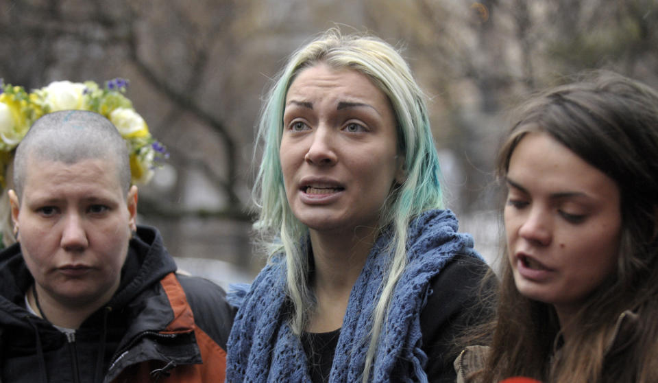 FILE - In this Wednesday, Dec. 21, 2011 file photo Aleksandra Nemchinova ,left, and Inna Shevchenko, center, and Oksana Shachko ,right, activists of the Women's Movement 'FEMEN' speak to the media in Kiev,Ukraine. The new face of France _ or at least the official postage stamp for the President Francois Hollande era _ is modeled after a Ukrainian woman who takes her top off to defend feminist causes. Hollande on Sunday unveiled the new stamp, meant to represent Marianne, a symbol of France since the revolution. Afterward, the artist said the image was modeled largely after Femen activist Inna Shevchenko. (AP Photo/Sergei Chuzavkov)