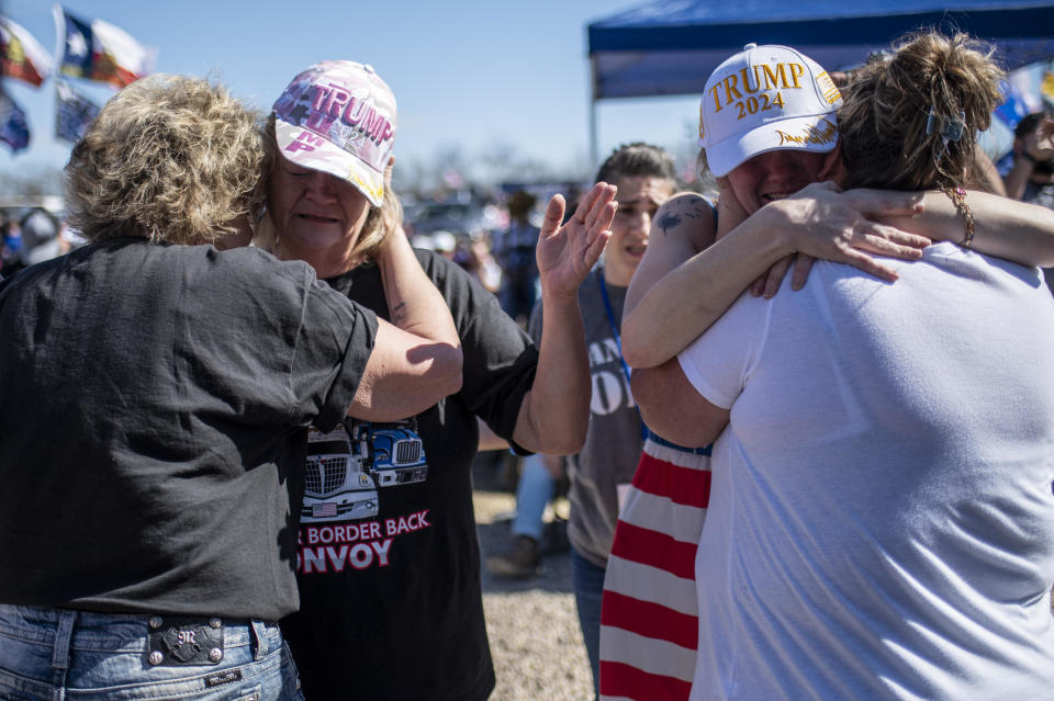 People embrace at the Take Back Our Border rally at Cornerstone Children's Ranch on Feb. 3, 2024, near Quemado, Texas.  / Credit: SERGIO FLORES/AFP via Getty Images