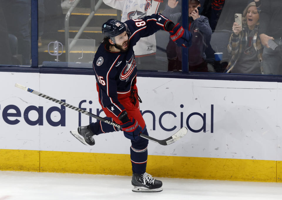 Columbus Blue Jackets forward Kirill Marchenko celebrates after his winning goal against the Ottawa Senators during an overtime period of an NHL hockey game in Columbus, Ohio, Sunday, April 2, 2023. (AP Photo/Paul Vernon)