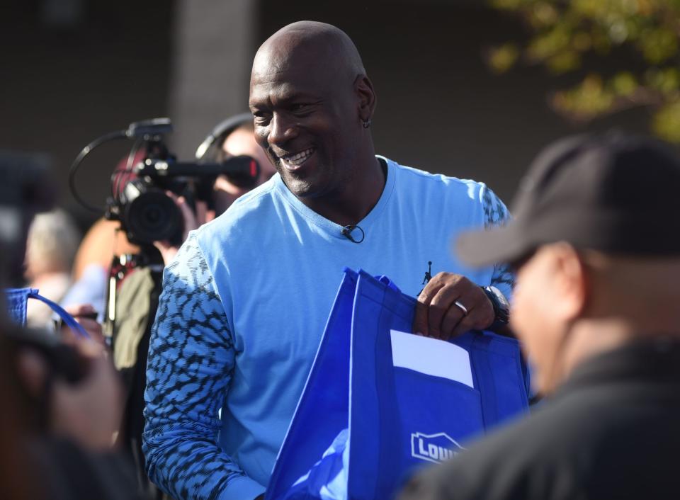 NBA legend and Wilmington native Michael Jordan hands out Thanksgiving meals to people impacted by Hurricane Florence at the Lowe's Home Improvement store in Wilmington, N.C., Tuesday, November 20, 2018.  [Matt Born/StarNews Photo]