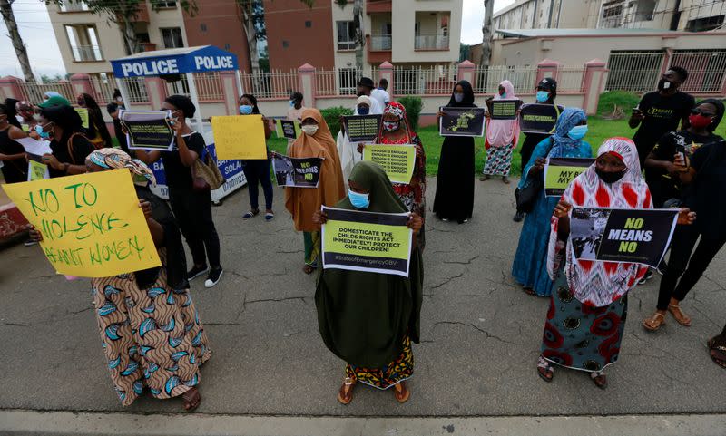 Protesters carry banners as they stage a demonstration to raise awareness about sexual violence in Abuja