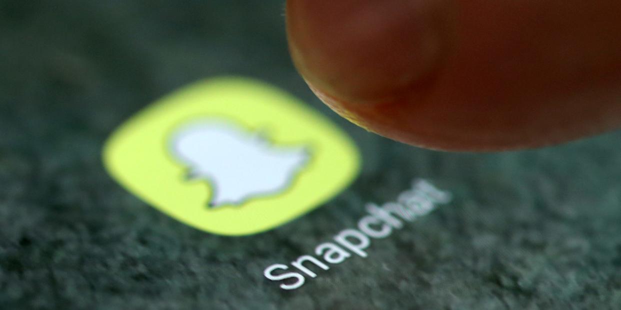 FILE PHOTO: The Snapchat app logo is seen on a smartphone in this picture illustration taken September 15, 2017. REUTERS/Dado Ruvic/Illustration