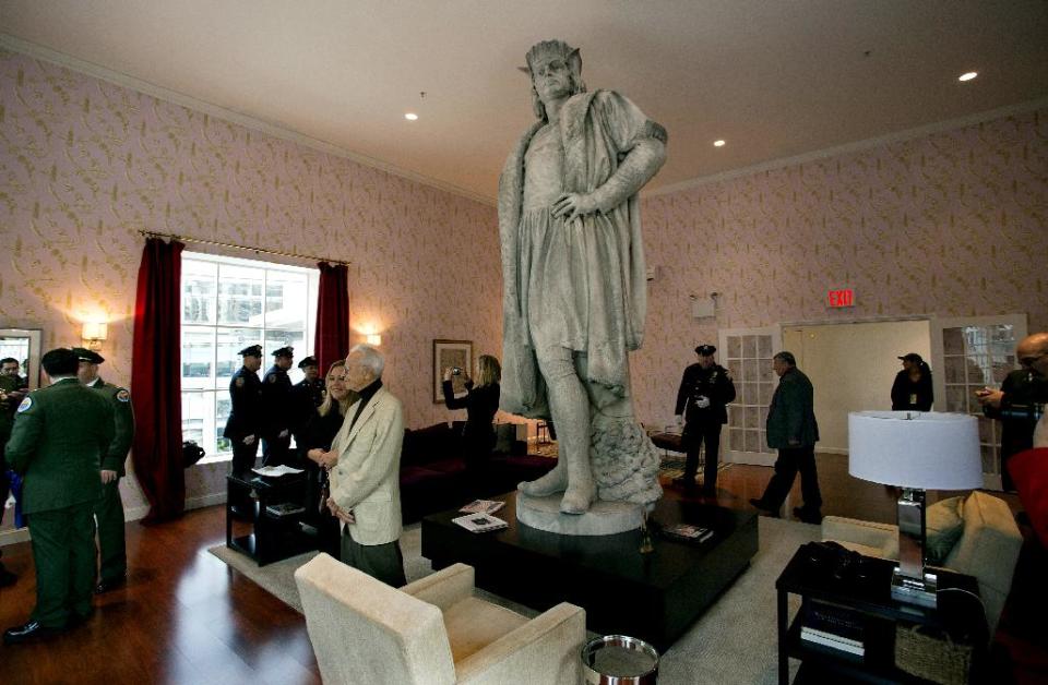 Leaders of the Italian-American community, civil servants from New York, including police and sanitation workers and other guests, stand in what is known as the living room created by artist Tatzu Nishi that surrounds Gaetano Russo's 1892 sculpture of Christopher Columbus 75 Feet Above Columbus Circle Sunday, Oct. 7, 2012, in New York. The art  installation “Tatzu Nishi: Discovering Columbus," which brings people to eye level with the Columbus statue, became part of an annual wreath laying ceremony that celebrates Columbus Day. (AP Photo/Craig Ruttle)