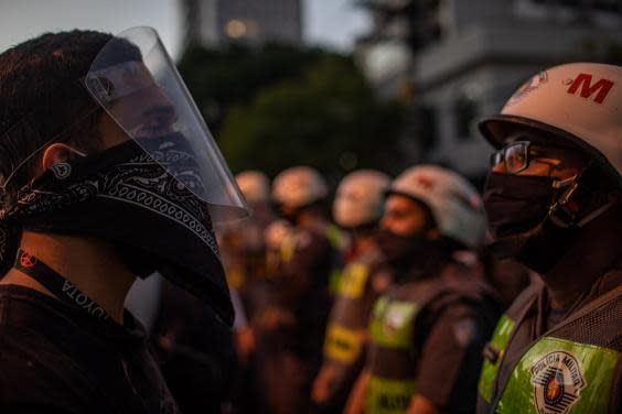 Pro-democracy protesters face off with military police during a protest against Bolsonaro (Getty Images)