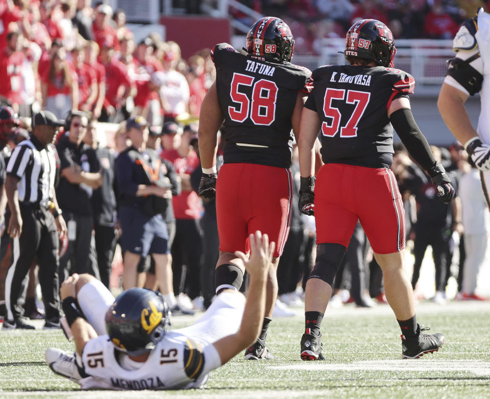 Utah defensive tackles Junior Tafuna (58) and Keanu Tanuvasa (57) walk back after hurrying California quarterback Fernando Mendoza (15) and injuring him during an NCAA college football game in Salt Lake City on,Saturday, Oct. 14, 2023. (Jeffrey D. Allred/The Deseret News via AP)