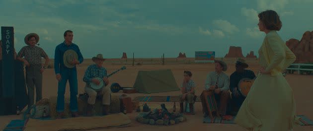 Rupert Friend (second from right) stands among cowboys played by Pere Mallen, Jean-Yves Lozac'h, Jarvis Cocker and Seu Jorge as he looks on at Maya Hawke, who plays teacher June Douglas in Wes Anderson's latest film 