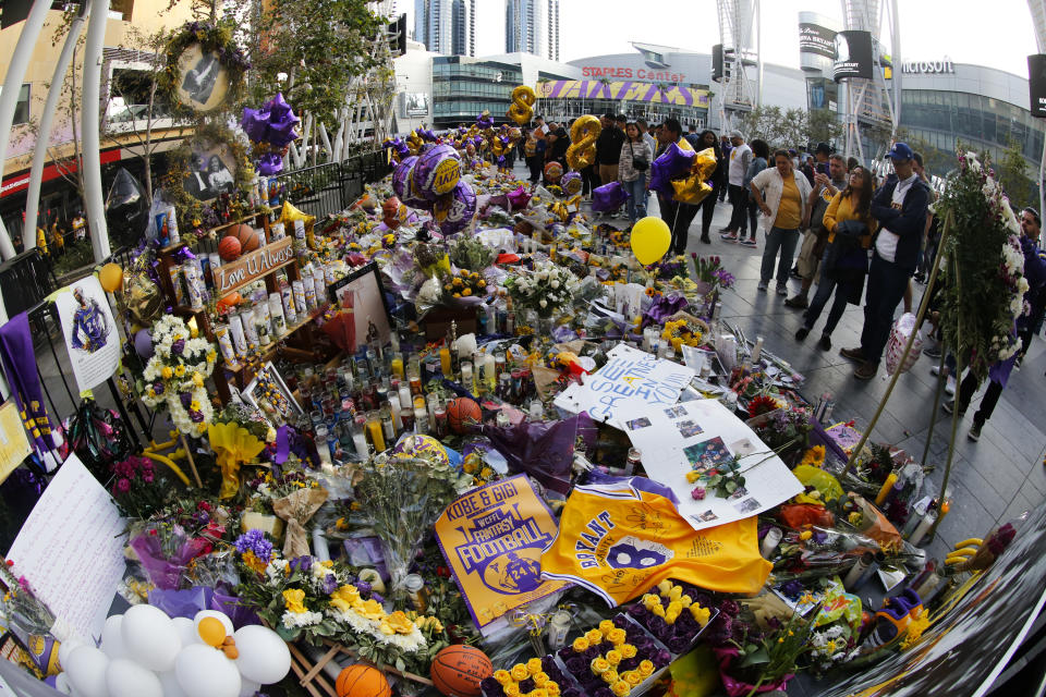 Fans gather to pay their respects at a memorial for the late Kobe Bryant near Staples Center prior to an NBA game between the Los Angeles Lakers and the Portland Trail Blazers at Staples Center Friday, Jan. 31, 2020, in Los Angeles. Bryant, the 18-time NBA All-Star who won five championships and became one of the greatest basketball players of his generation during a 20-year career with the Los Angeles Lakers, died in a helicopter crash Sunday. (AP Photo/Ringo H.W. Chiu)
