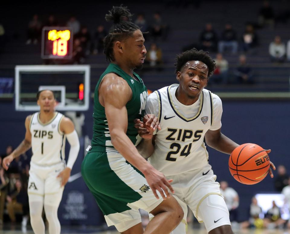 Akron Zips guard Ali Ali drives to the basket against Ohio guard Miles Brown during the first half, Tuesday, Jan. 23, 2024.