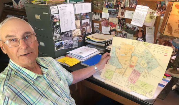 PHOTO: Tom Barnes sits in his home office, holding a map he drew of his family’s land holdings dating back to when the Barneses arrived in this area near Williamsport, Ohio, in 1951. (Dan Gearino)