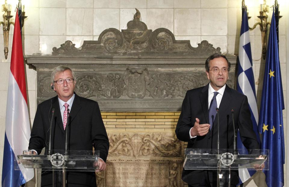 Greek Prime Minister Antonis Samaras, right, speaks next to Jean Claude Junker, Prime Minister, of Luxembourg and President of Eurogroup during a join news conference after their meeting in Athens, Wednesday, Aug. 22, 2012. The meeting is the first of several Samaras will hold this week with European leaders to press the case for granting Athens more time to complete its reforms. He will be in Berlin on Friday to speak with German Chancellor Angela Merkel and in Paris on Saturday with French President Francois Hollande. (AP Photo/Petros Giannakouris)