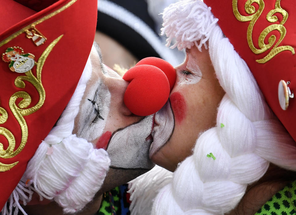 Two revellers kiss for photographers in Cologne's city center when thousands of revelers dressed in carnival costumes celebrate the start of the street carnival in Cologne, Germany, Thursday, February 28, 2019.&nbsp;