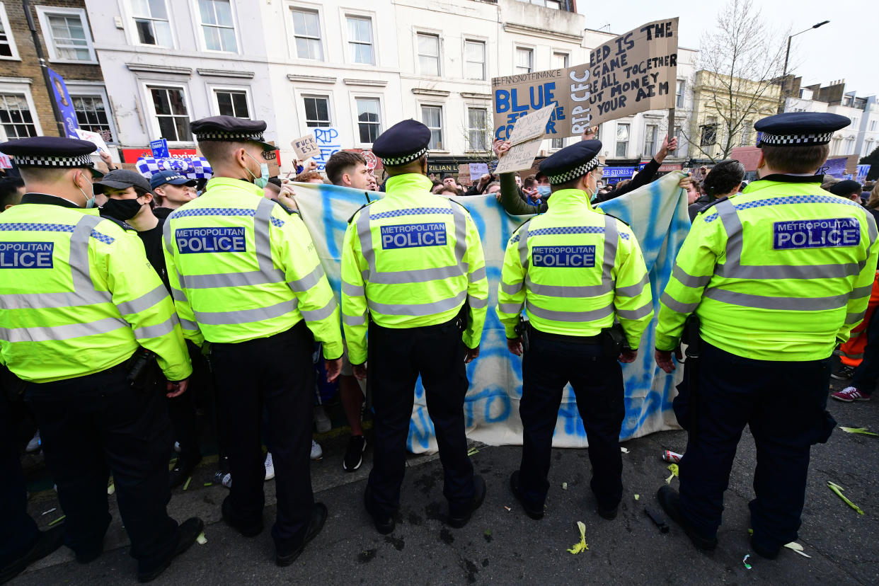 Police look on as protests take place against Chelsea's involvement in the new European Super League outside Stamford Bridge, London. Picture date: Tuesday April 20, 2021.