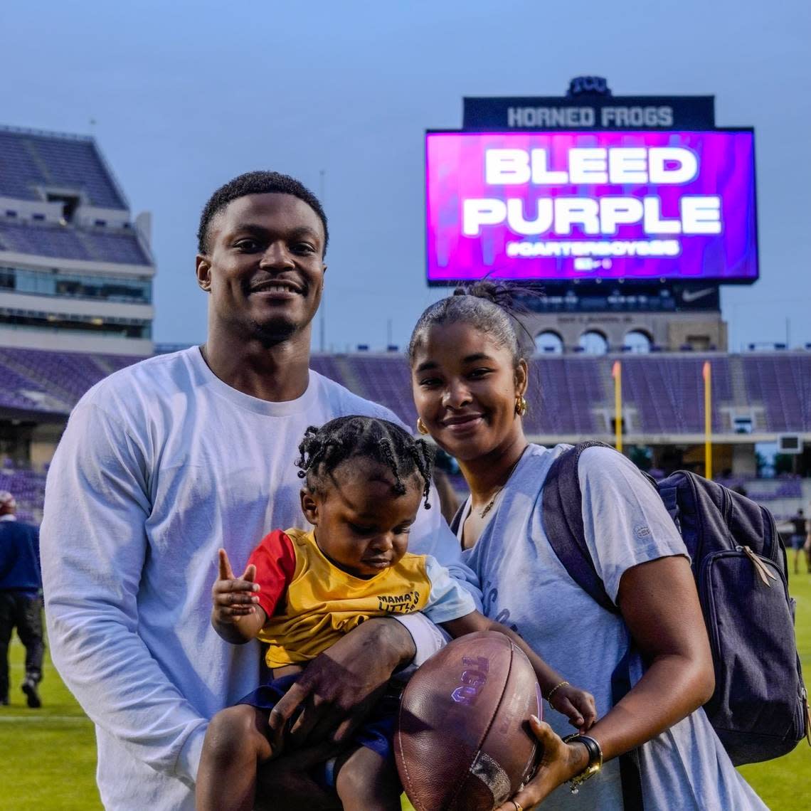 TCU safety Bud Clark, his girlfriend Nesha Cooper (right) and their son Kenzo Clark after a TCU practice at Amon G. Carter Stadium on Friday.