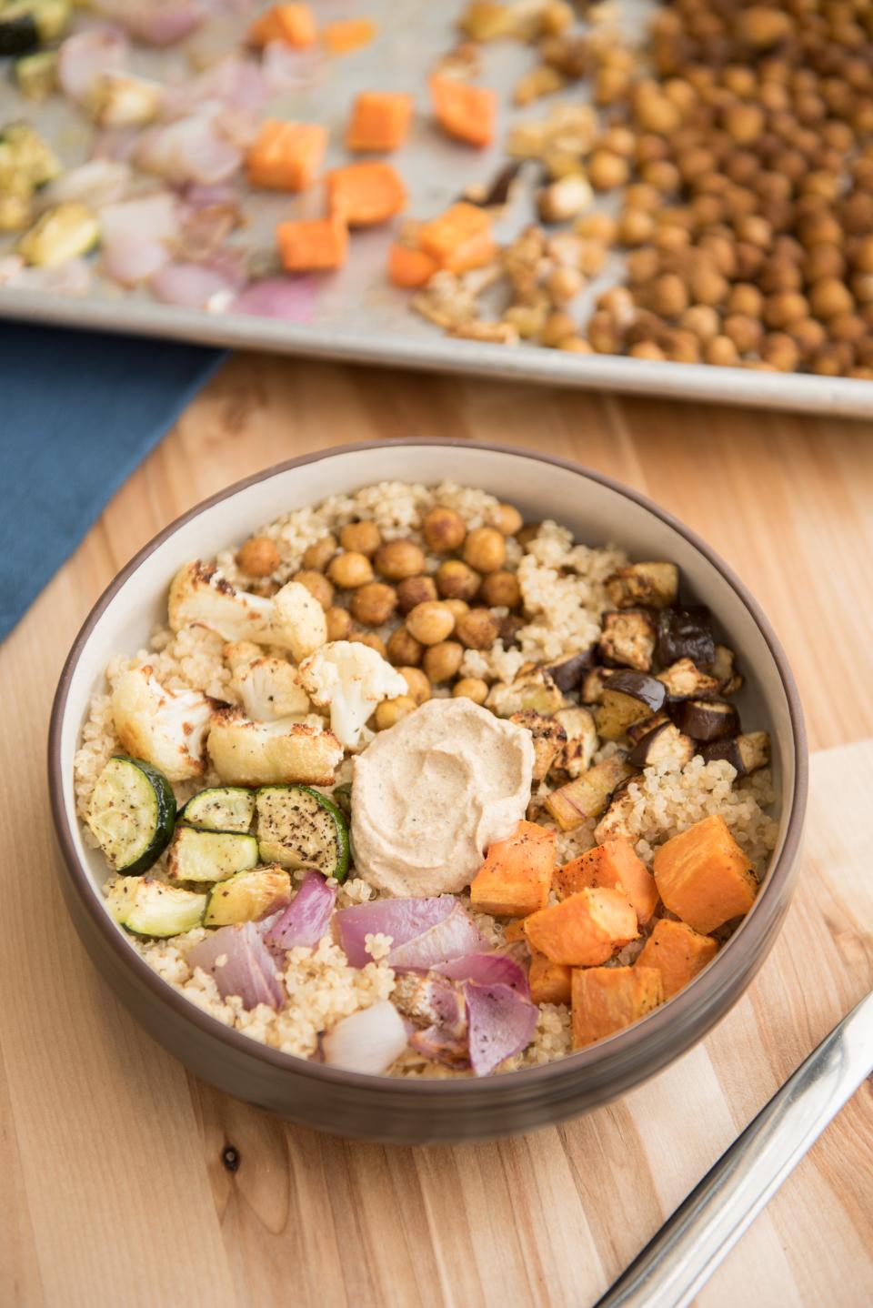 Moroccan Sheet-Pan Buddha Bowl calls for a mix of vegetables that includes sweet potatoes, chickpeas and eggplalnt.