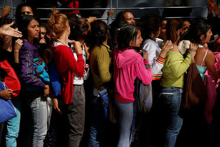 Women queue on the street as they try to buy diapers outside a pharmacy in Caracas, Venezuela March 18, 2017. REUTERS/Carlos Garcia Rawlins