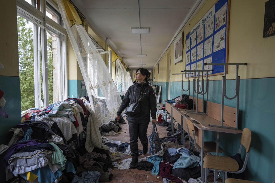 A school director Iryna Homenko walks in the hall of the school damaged by an airstrike from Russian forces in Chernihiv, Ukraine, Wednesday, April 13, 2022. (AP Photo/Evgeniy Maloletka)