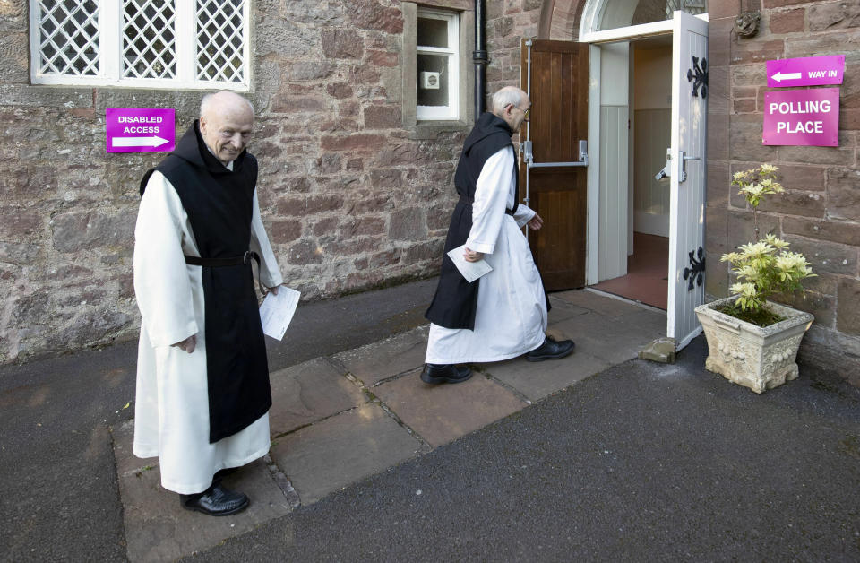 Monks Father Leonard Norman, left, and Father Mark Caira from the Sancta Maria Abbey in Garvald, Scotland, arrive at a polling station to cast their votes for the European Parliamentary election. (Jane Barlow/PA via AP)