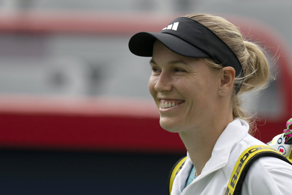 Caroline Wozniacki of Denmark, smiles as she arrives at center court for her match against Kimberly Birrell, of Australia, during the National Bank Open women's tennis tournament in Montreal, Tuesday, Aug. 8, 2023. (Christinne Muschi/The Canadian Press via AP)
