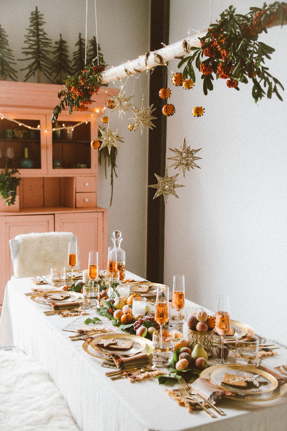 <p>Take your Christmas centerpiece to new “heights” by hanging some ornaments and pendants above your dining room table. The result? A setup with floor-to-ceiling appeal.</p><p><a href="https://blog.jungalow.com/2015/11/a-boho-ho-holiday-party-with-pier-1.html" rel="nofollow noopener" target="_blank" data-ylk="slk:Via the Jungalow;elm:context_link;itc:0;sec:content-canvas" class="link "><em>Via the Jungalow</em></a></p>