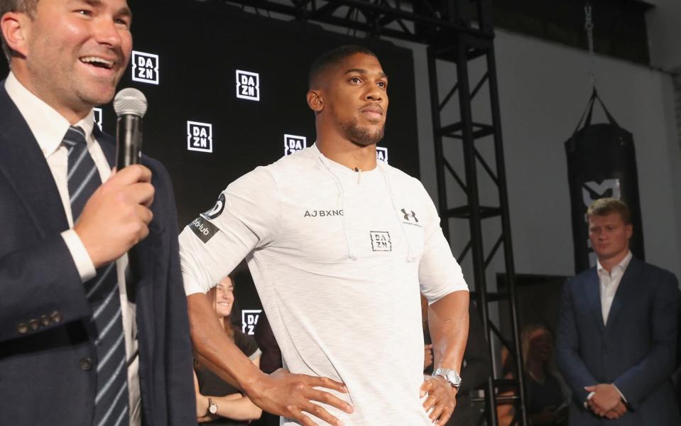 Anthony Joshua (centre) is putting his belts on the line against Alexander Povetkin (right) - Getty Images North America