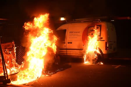 An AT&T truck burns as protests riot in Oakland, California, U.S. following the election of Republican Donald Trump as President of the United States November 9, 2016. REUTERS/Noah Berger