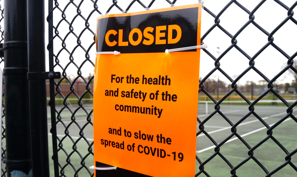 The tennis court at the Rev. Dr. Martin Luther King Jr. Park in Minneapolis remains closed and locked due to the COVID-19 pandemic. Wednesday, April 29, 2020. Some Minnesota recreation restrictions have been lifted, including golf which requires social distancing. (AP Photo/Jim Mone)