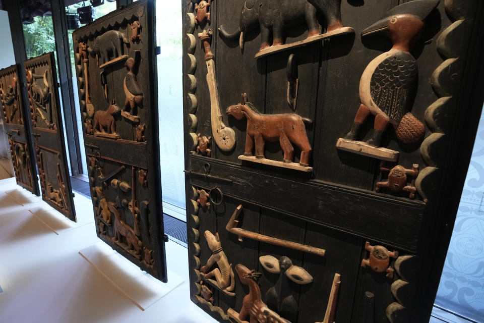 The doors of King Glele 'palace, from Benin 19th century, are pictured at the Quai Branly–Jacques Chirac museum, Monday, Oct. 25, 2021 in Paris. In a decision with potential ramifications across European museums, France is displaying 26 looted colonial-era artifacts for one last time before returning them home to Benin. The wooden anthropomorphic statues, royal thrones and sacred altars were pilfered by the French army in the 19th century from Western Africa. (AP Photo/Michel Euler)